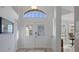 Bright foyer featuring high ceilings, tile flooring, and a view into the dining and living areas at 150 Center Oak Cir, Spring Hill, FL 34609