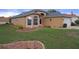Inviting single-story home with a well-manicured lawn and decorative landscaping details at 150 Center Oak Cir, Spring Hill, FL 34609