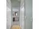 Hallway view leading to bathroom with double doors and tile flooring at 150 Center Oak Cir, Spring Hill, FL 34609