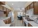 Eat-in kitchen area features tile floors, a ceiling fan, and oak cabinets with white appliances at 150 Center Oak Cir, Spring Hill, FL 34609