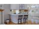 View of the kitchen area with bar seating, featuring an open layout connected to the living room at 150 Center Oak Cir, Spring Hill, FL 34609