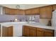 Open kitchen with wood cabinetry and views into the living room at 150 Center Oak Cir, Spring Hill, FL 34609