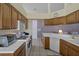 A bright kitchen features tile flooring, light countertops and cabinets and recessed lights at 150 Center Oak Cir, Spring Hill, FL 34609