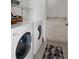 Functional laundry room with modern appliances, a utility sink, and practical storage solutions at 150 Center Oak Cir, Spring Hill, FL 34609