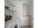 Bright laundry room featuring a washer, dryer, utility sink, and built-in shelving at 150 Center Oak Cir, Spring Hill, FL 34609
