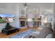 Bright living room with a fireplace, TV and an open layout leading to the kitchen area at 150 Center Oak Cir, Spring Hill, FL 34609