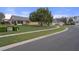 Suburban street view showcasing a well-maintained lawn and mature trees in a quiet neighborhood at 150 Center Oak Cir, Spring Hill, FL 34609