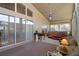 Sunroom with hot tub, fan, large windows, and seating at 150 Center Oak Cir, Spring Hill, FL 34609