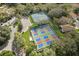 Aerial shot showcasing well-maintained tennis and pickleball courts surrounded by lush greenery in a vibrant community at 150 Center Oak Cir, Spring Hill, FL 34609
