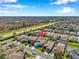 Aerial view showcasing a residential area with numerous houses and a nearby highway, and natural landscape at 1801 Loch Haven Ct, Trinity, FL 34655