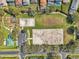 This aerial view highlights the community recreation area with playground and sports courts at 1801 Loch Haven Ct, Trinity, FL 34655