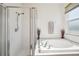 This bathroom showcases a glass-enclosed shower and a large, modern bathtub for relaxation at 1801 Loch Haven Ct, Trinity, FL 34655