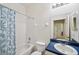 Bright bathroom features a combined tub and shower, toilet and vanity at 1801 Loch Haven Ct, Trinity, FL 34655