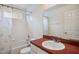Bright bathroom featuring a shower-tub combination with a rust colored countertop and a large mirror at 1801 Loch Haven Ct, Trinity, FL 34655