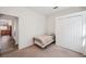 Simple bedroom with view to living area and closet with paneled doors at 1801 Loch Haven Ct, Trinity, FL 34655