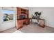 Bedroom showcasing a custom wooden workstation with a large window and a carpeted floor at 1801 Loch Haven Ct, Trinity, FL 34655