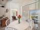 Charming dining area with views of the patio, adjacent to the living room and a bedroom at 1801 Loch Haven Ct, Trinity, FL 34655