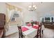 Bright dining room with wood floors, a dining table set for four, and a large window at 1801 Loch Haven Ct, Trinity, FL 34655