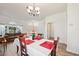 Dining area bathed in natural light, with a chandelier, a table for four and view to the entry way at 1801 Loch Haven Ct, Trinity, FL 34655