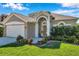 Home featuring a two-car garage, and manicured landscaping enhancing its curb appeal at 1801 Loch Haven Ct, Trinity, FL 34655