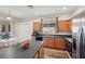 Bright kitchen features a breakfast bar, a stainless steel refrigerator, and ample cabinet space at 1801 Loch Haven Ct, Trinity, FL 34655