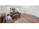 Cozy living room with natural light, wood floors, and comfortable seating at 1801 Loch Haven Ct, Trinity, FL 34655