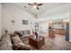 Inviting living room with vaulted ceilings, wood-look flooring, and comfortable seating adjacent to the kitchen at 1801 Loch Haven Ct, Trinity, FL 34655
