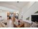Spacious living room with a ceiling fan, staircase, wood floors, and a kitchen in the background at 1801 Loch Haven Ct, Trinity, FL 34655
