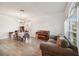 Open living area featuring wood floors, neutral walls, large windows and a charming piano at 1801 Loch Haven Ct, Trinity, FL 34655