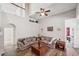 Open-concept living room with wood floors, high ceilings, comfortable seating, and natural light at 1801 Loch Haven Ct, Trinity, FL 34655