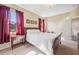 Bright main bedroom with a window letting in natural light, complemented by light walls and carpet at 1801 Loch Haven Ct, Trinity, FL 34655