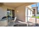 Covered patio with a glass table, seating, and access to the backyard through sliding glass doors at 1801 Loch Haven Ct, Trinity, FL 34655