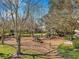 Community playground featuring play structures, shaded by trees, and landscaped surroundings, enhancing the neighborhood's appeal at 1801 Loch Haven Ct, Trinity, FL 34655