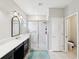 Bathroom featuring a large glass enclosed shower, marble countertops and a vanity mirror at 18601 Noble Caspian Dr, Lutz, FL 33558