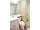 Well-maintained bathroom features glass block, tiled shower, and updated vanity at 1955 Abrico Dr # G12, Lutz, FL 33558