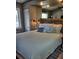 Bright bedroom with a full bed, mirrored wall, and decorative pillows at 1955 Abrico Dr # G12, Lutz, FL 33558
