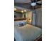Well-lit bedroom features a full bed, mirrored wall, and neutral décor at 1955 Abrico Dr # G12, Lutz, FL 33558