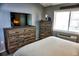 Cozy bedroom featuring rustic wood furniture, a large window, and neutral gray walls at 1955 Abrico Dr # G12, Lutz, FL 33558