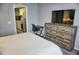 Comfortable bedroom with rustic wood furniture, a TV, and a desk at 1955 Abrico Dr # G12, Lutz, FL 33558
