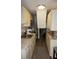 Narrow kitchen with white cabinets, granite counters, stainless steel appliances at 1955 Abrico Dr # G12, Lutz, FL 33558