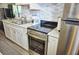 Kitchen features sleek stainless steel appliances and pristine white cabinetry at 1955 Abrico Dr # G12, Lutz, FL 33558