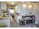 Efficient kitchen with white cabinets, granite countertops, and a cozy breakfast bar at 1955 Abrico Dr # G12, Lutz, FL 33558