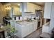 Efficient kitchen with white cabinets, granite countertops, and stainless steel appliances at 1955 Abrico Dr # G12, Lutz, FL 33558