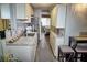 Efficient kitchen with white cabinets, granite countertops, and stainless steel appliances at 1955 Abrico Dr # G12, Lutz, FL 33558