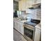 Kitchen features sleek stainless steel appliances and pristine white cabinetry at 1955 Abrico Dr # G12, Lutz, FL 33558