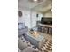 Stylish living room boasts gray sofa, ottoman, and a mirrored wall for an open feel at 1955 Abrico Dr # G12, Lutz, FL 33558