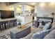 Comfortable living room open to kitchen with gray sofa, ottoman, TV, and dining table at 1955 Abrico Dr # G12, Lutz, FL 33558