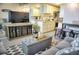 Comfortable living room open to kitchen with gray sofa, ottoman, TV, and dining table at 1955 Abrico Dr # G12, Lutz, FL 33558