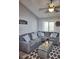Inviting living room with cozy gray sectional and modern ceiling fan at 1955 Abrico Dr # G12, Lutz, FL 33558