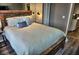 Relaxing main bedroom with a rustic wood frame bed and hardwood floors at 1955 Abrico Dr # G12, Lutz, FL 33558